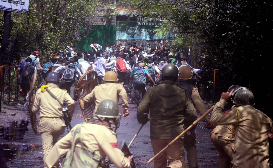 Police and CRPF men chasing away students during clashes in the vicinity of Lal Chowk in Srinagar on Monday. Students of the SP College assembled on the Maulana Azad Road and started pelting stones on security forces causing blockade of one of the busiest roads in Srinagar. PTI Police and CRPF men chasing away students during clashes in the vicinity of Lal Chowk in Srinagar on Monday. Students of the SP College assembled on the Maulana Azad Road and started pelting stones on security forces causing blockade of one of the busiest roads in Srinagar. PTI