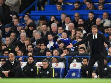 Chelsea's Antonio Conte (R) shouts instructions as Manchester City's Pep Guardiola (L) sits and watches. AFP