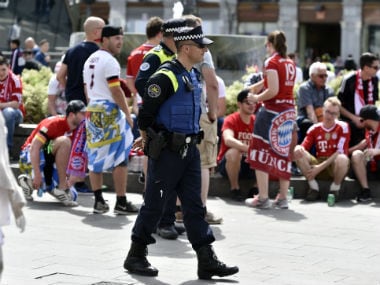 File image of Spanish policemen at the Plaza del Sol at the Santiago Bernabeu stadium in Madrid. AFP