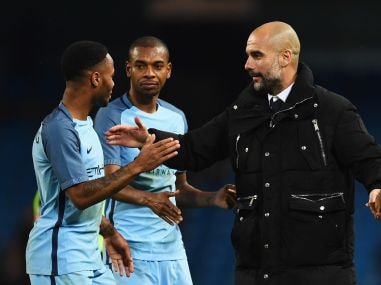 Pep Guardiola, manager of Manchester City, with Raheem Sterling and Fernandinho. Getty
