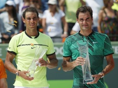Rafael Nadal and Roger Federer hold their trophies after Federer won the Miami Open title. AP