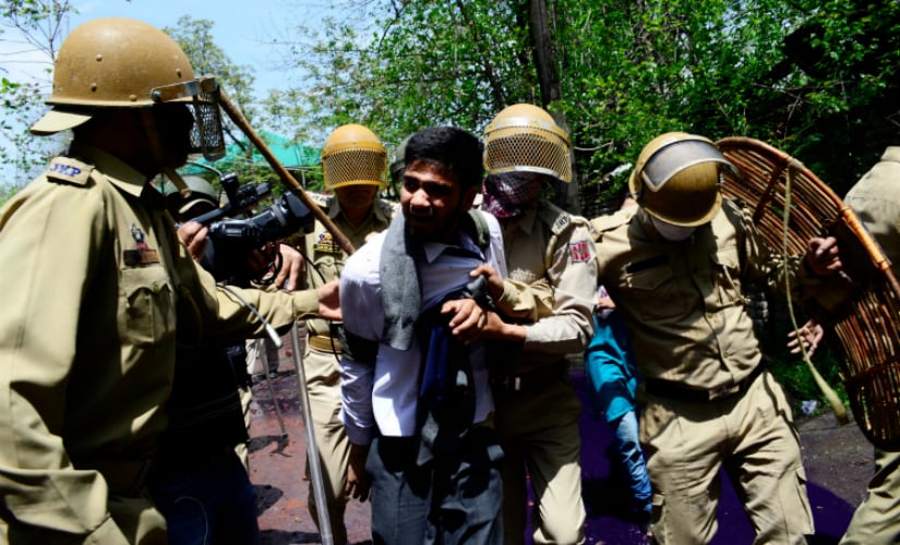 Kashmir police arresting a student of SP College in Srinagar, six students were reportedly arrested by the police on Monday. Firstpost/ Azan Shah