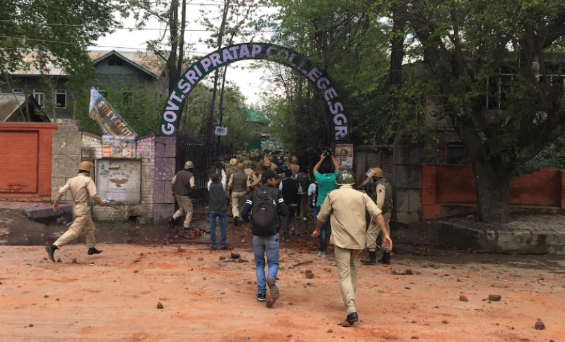 Kashmir police charging the stone-throwing students inside SP College Srinagar. Firstpost/Sameer Yasir