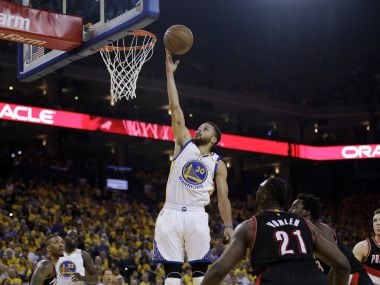 Golden State Warriors' Stephen Curry (30) scores against the Portland Trail Blazers. AP