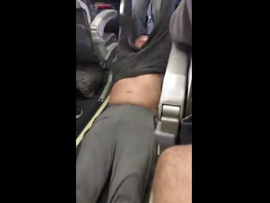 United Airlines row: Man dragged off Flight 3411 in Chicago launches legal action United Airlines row: Man dragged off Flight 3411 in Chicago launches legal action