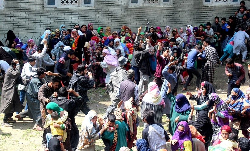 Four militants giving their slain comrade a gun salute in Kulgam. Firstpost/ Hilal Shah