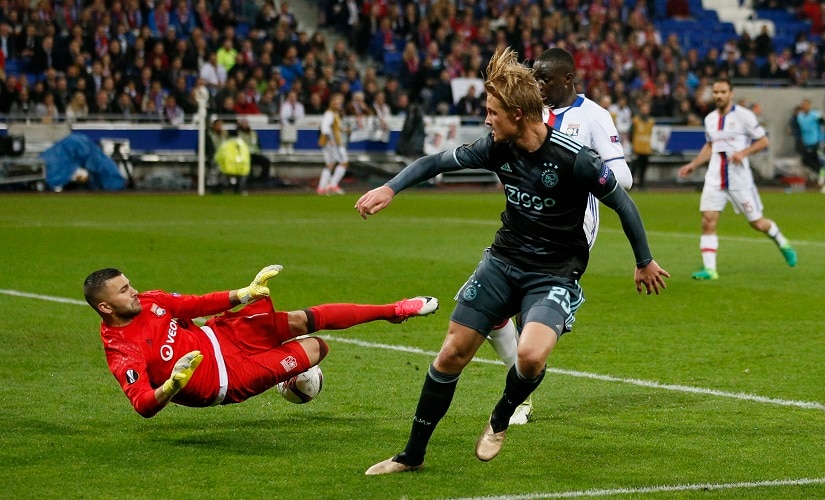 Lyon's Anthony Lopes in action with Ajax's Kasper Dolberg. Reuters