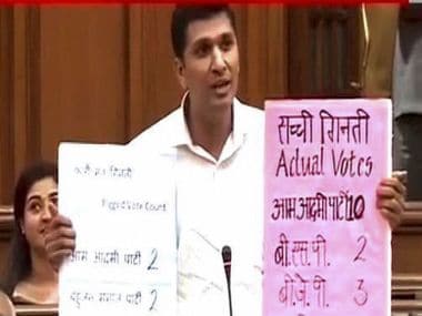 AAP leader Saurabh Bharadwaj in the Delhi Assembly demonstrating the 'faulty' EVMs. PTI