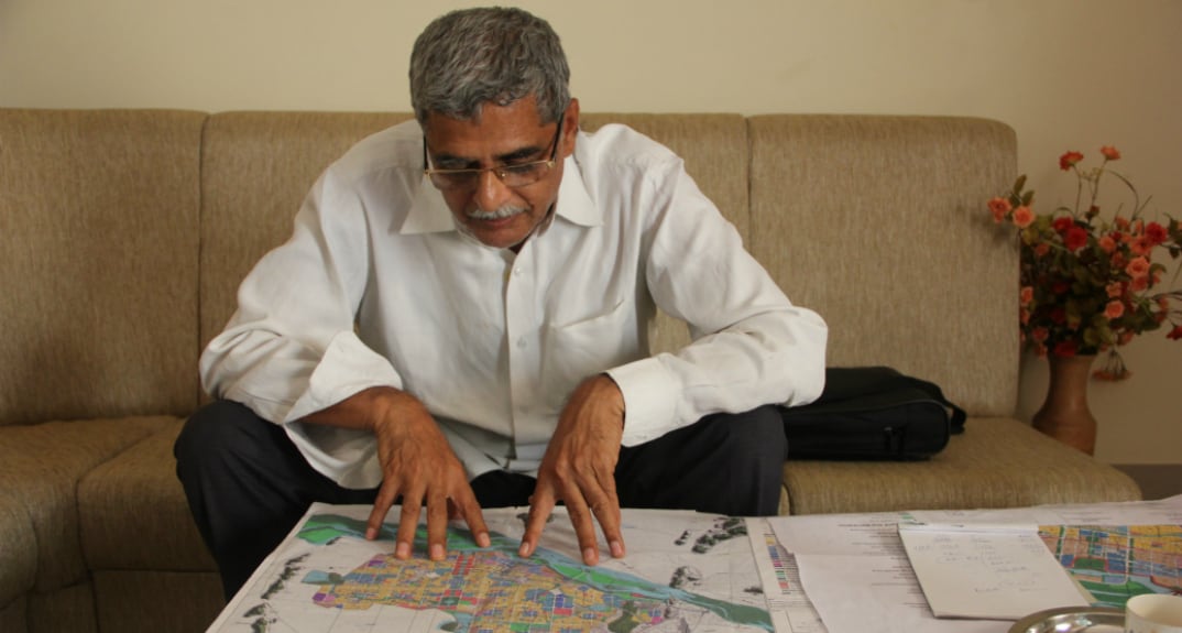 Anumolu Gandhi examines the CRDA plans. Photo - Swati Sanyal Tarafdar for Firstpost