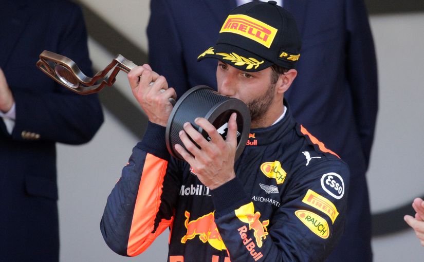 Red Bull's Daniel Ricciardo celebrates third place on the podium with the trophy. Reuters