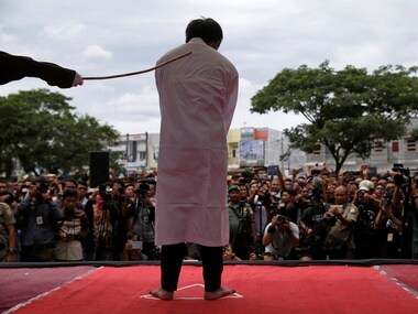 An Indonesian man is publicly caned for having gay sex, in Banda Aceh. Reuters