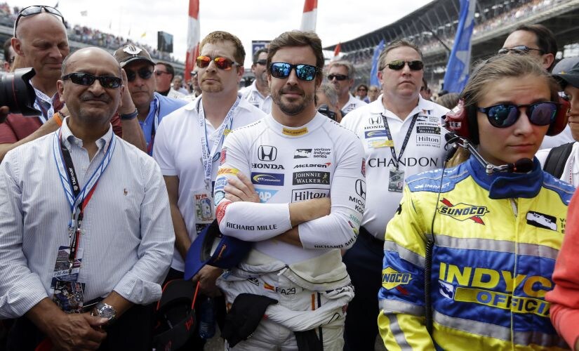 Fernando Alonso waits near his car for the start of the Indianapolis 500. AP