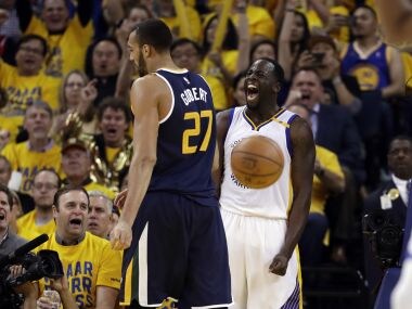 Golden State Warriors' Draymond Green, right, celebrates after scoring against Utah Jazz. AP