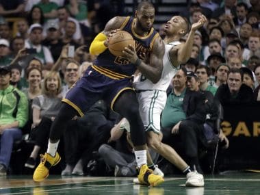 Cleveland Cavaliers' LeBron James, left, muscles his way to the basket on Friday. AP