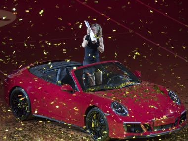 Laura Siegemund poses in the winner's car with her trophy, after she won the final match. AFP