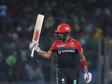 Royal Challengers Bangalore captain Virat Kohli raises his bat after reaching his fifty. SportzPics