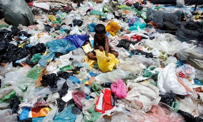 A child rag picker sorts scrap in Siliguri. Reuters