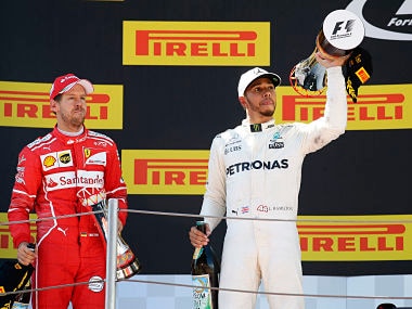 Mercedes driver Lewis Hamilton of Britain and Ferrari driver Sebastian Vettel of Germany celebrate on the podium after placing first and second at the Spanish Formula One Grand Prix. AP