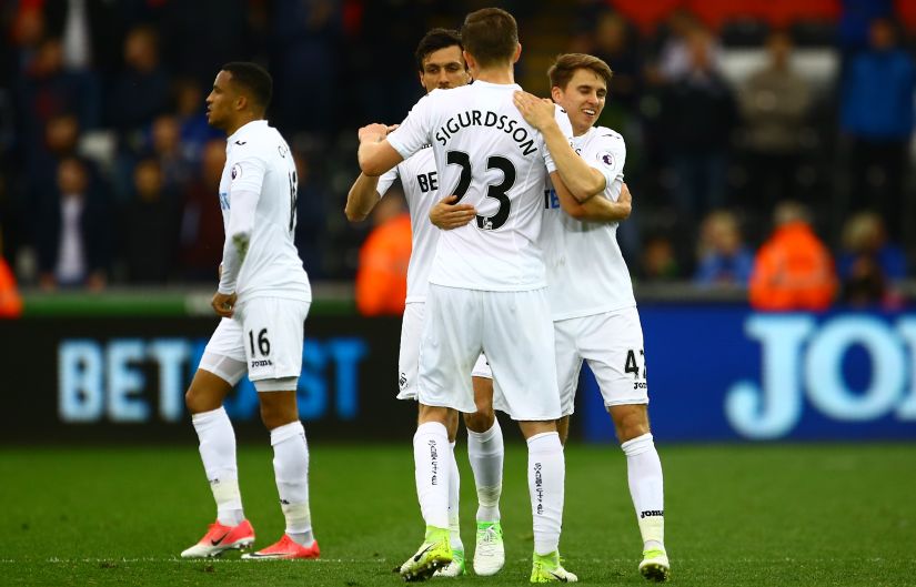 Swansea players celebrate on the pitch after their win over Everton at The Liberty Stadium. AFP