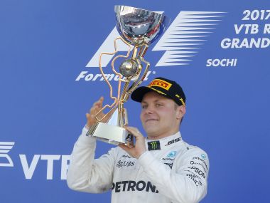 Winner and Mercedes driver Valtteri Bottas of holds the Russian GP trophy on the podium. Reuters