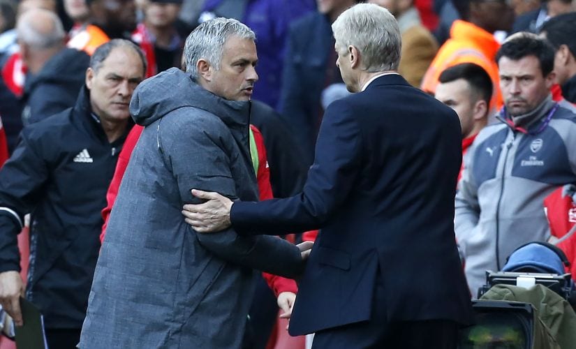 Arsenal's manager Arsene Wenger shakes hands with Manchester United's manager Jose Mourinho (2nd L) after Arsenal's win. AFP