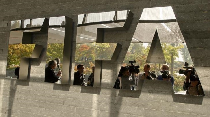 Journalists are reflected in a logo at the FIFA headquarters after a meeting of the executive committee in Zurich, in a file photo. REUTERS/Arnd Wiegmann