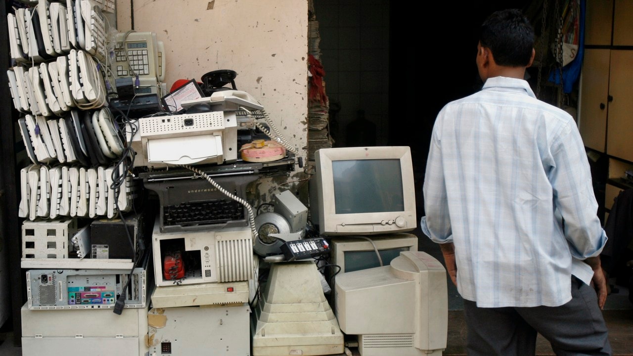 A man walks past electronic waste at a junk shop in Mumbai. Reuters