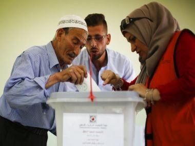 A Palestinian casts his vote at a polling station in the West Bank city of Nablus on Saturday. PTI