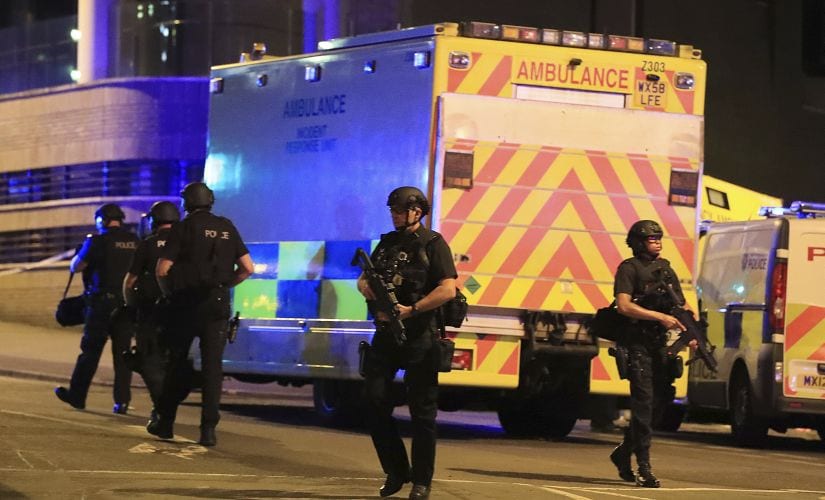 Armed police work at Manchester Arena. AP