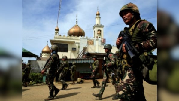 Philippines forces carry out 'surgical air strikes' on Islamist militants, martial law continues