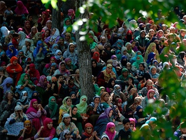 Kashmiri villagers watch the funeral procession of Hizbul commander Sabzar Bhat in Rathsuna Tral, near Srinagar. Getty Images
