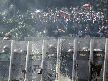Riot police prepare to confront Opposition activists. Getty Images