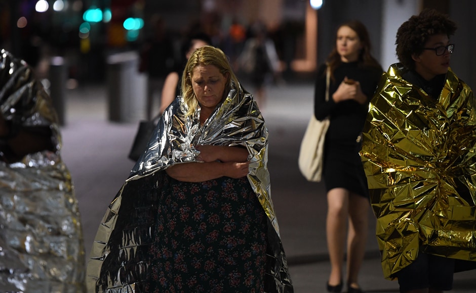 Members of the public, wrapped in emergency blankets leave the scene of the terror attack on London Bridge in central London Saturday. AFP Members of the public, wrapped in emergency blankets leave the scene of the terror attack on London Bridge in central London Saturday. AFP