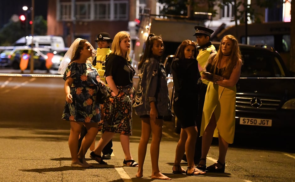 Women stand at a police cordon set up in London on Sunday morning. Armed police opened fire during what they described as a Women stand at a police cordon set up in London on Sunday morning. Armed police opened fire during what they described as a