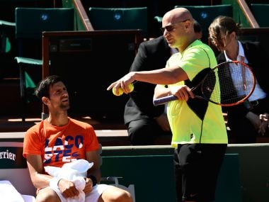 Novak Djokovic (L) with Andre Agassi during a training session. AFP
