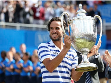 Spain's Feliciano Lopez celebrates with the trophy after winning the final against Croatia's Marin Cilic. AP