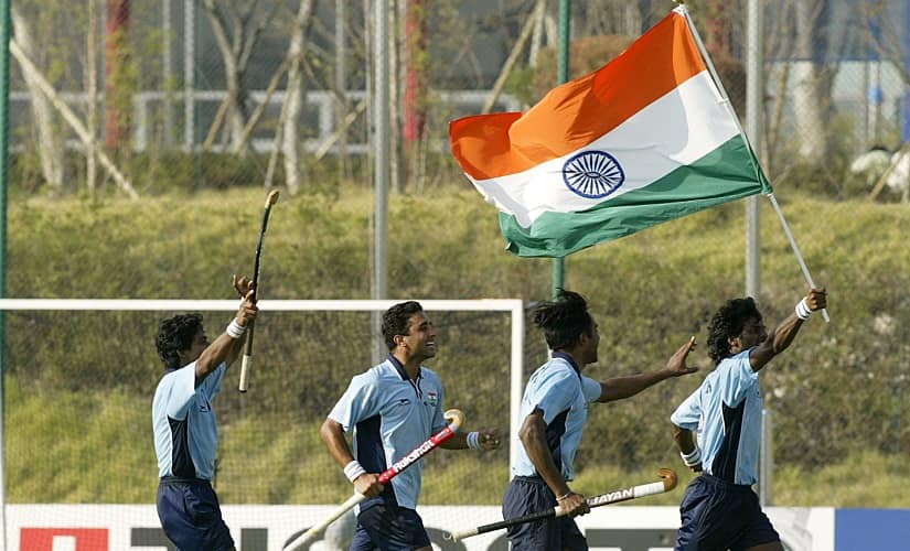 Dhanraj Pillay carries India’s flag after their win over Pakistan in the semi-final of the 14th Asian Games in 2002. REUTERS