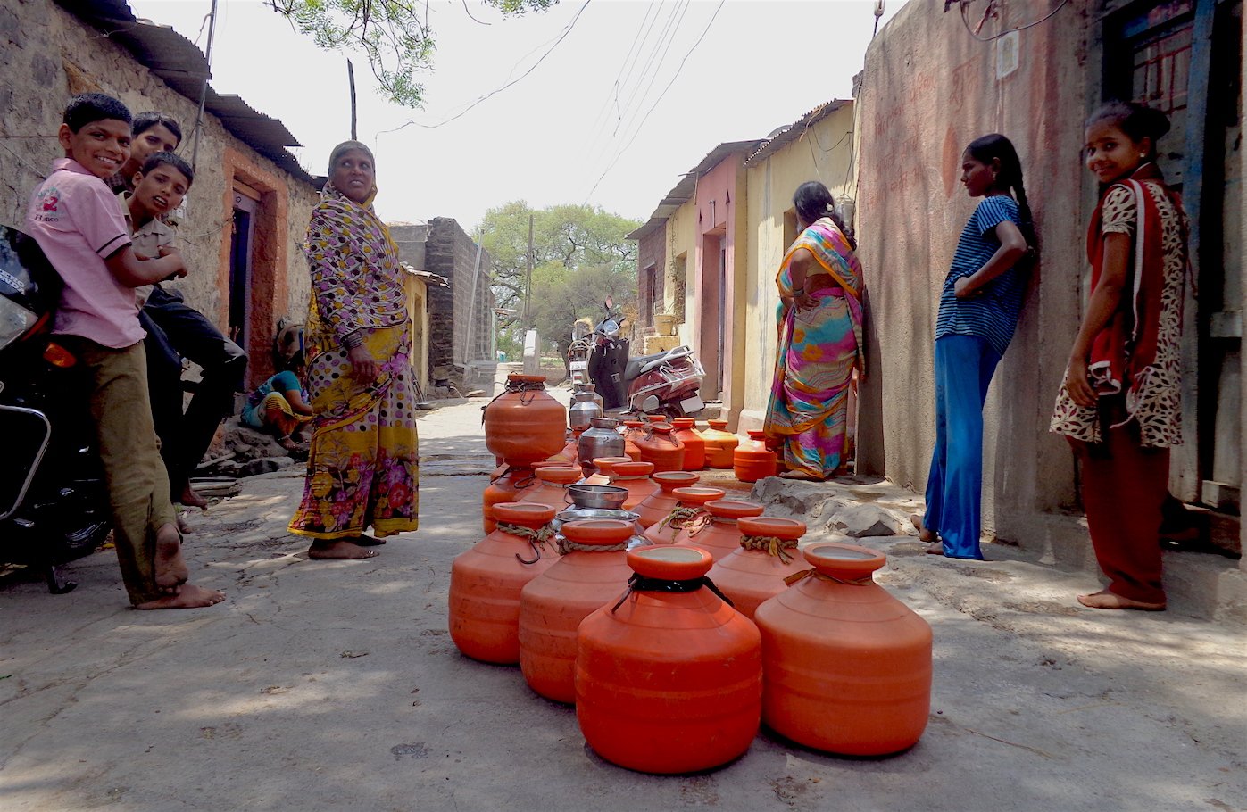 A line of orange pots outside the house of a local teacher who opens up his private borewell to the public a few times each week in Takwiki village. Parth MN