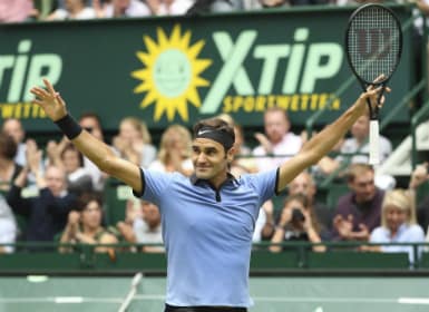Roger Federer celebrates his victory in the final match against Germany's Alexander Zverev at Halle Open. AP