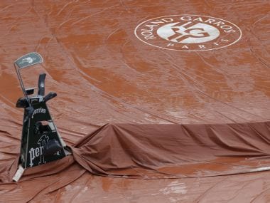 Philippe-Chatrier Court covered by a tarp during a downpour at Roland Garros. AFP