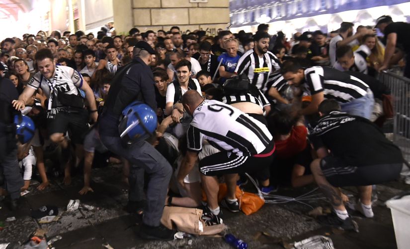 Juventus' fans flee from Turin's San Carlo Square following panic created by the explosion of firecrackers on Saturday. REUTERS