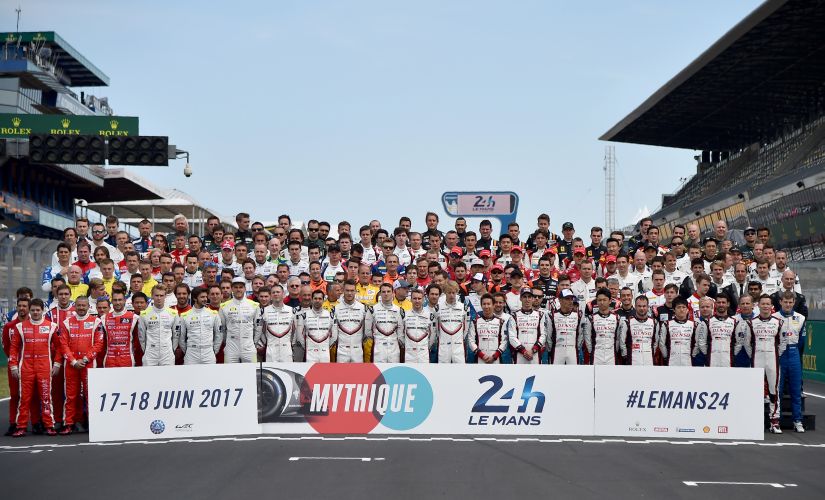 Drivers pose for picture on the race track before a free practice session for the Le Mans 24 hours endurance race. AFP