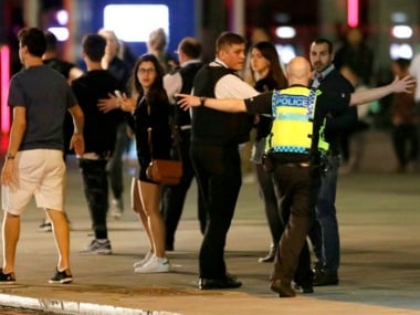 A Police officer clears people away from the area near London Bridge after an incident in central London on Saturday. AP