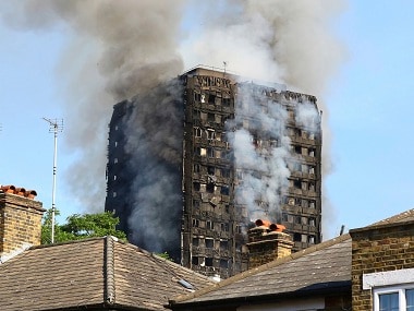 Smoke billows from from a high-rise apartment building on fire in London, Wednesday, June 14, 2017. A massive fire raced through the 27-story high-rise apartment building in west London early Wednesday, sending at least 30 people to hospitals, emergency officials said. AP