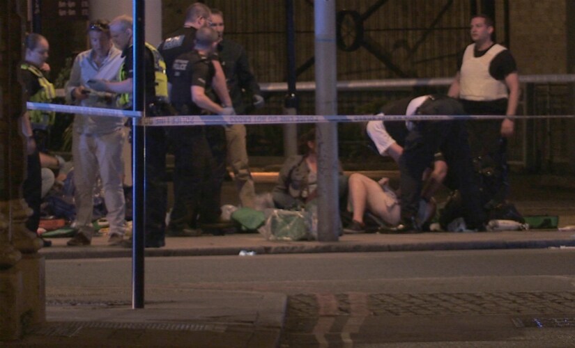 People receive medical attention in Thrale Street near London Bridge following an attack on 4 June, 2017.