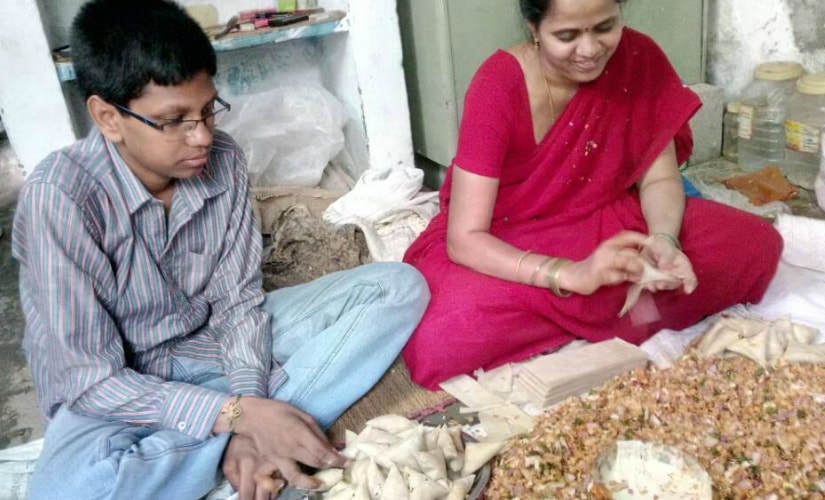 Mohan Abhyas with his mother as she prepares samosas. Firstpost/TS Sudhir