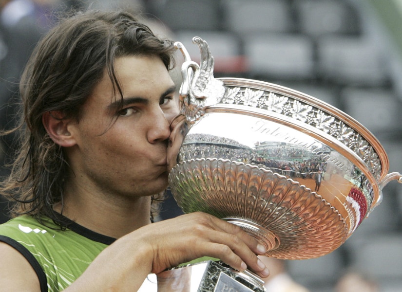 Rafael Nadal kisses the French Open trophy after defeating Argentina's Mariano Puerta in the 2005 French Open. AP