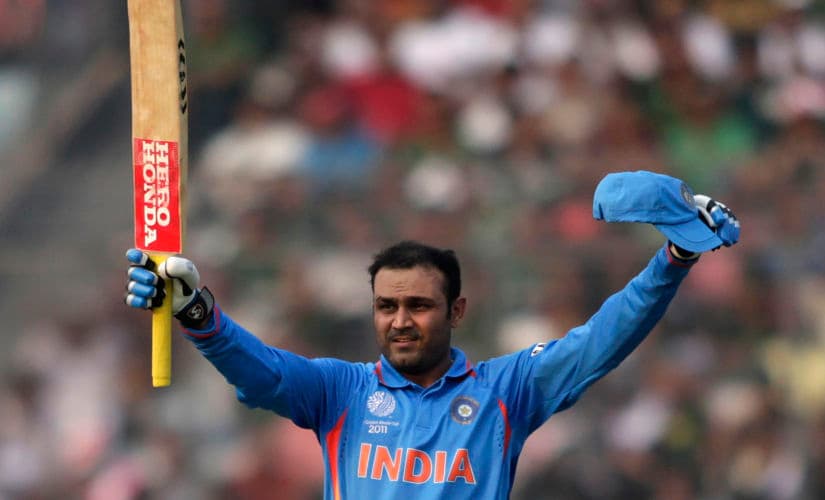 India's Virender Sehwag celebrates scoring his century during the World Cup match against Bangladesh in Dhaka. Reuters.