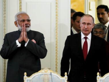 Narendra Modi with Vladimir Putin in St. Petersburg on Thursday. AP/PTI