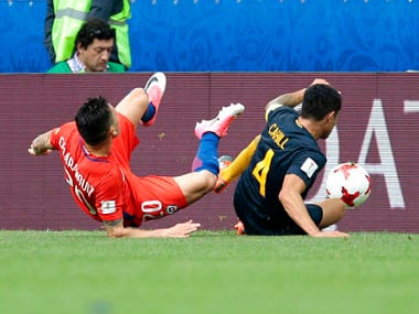 Australia's Tim Cahill, right, brings down Chile's Charles Aranguiz. AP